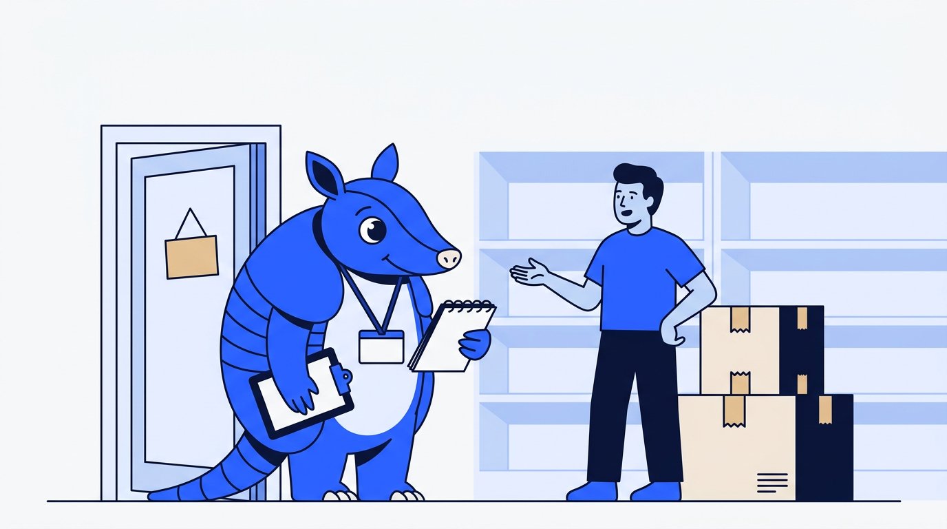Arlo the armadillo listens with a notepad while a shop owner standing beside packed moving boxes explains